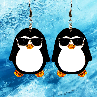 Black and white penguin earrings wearing sunglasses.