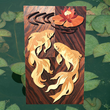Carved wooden artwork featuring goldfish and a water lily on a dark background.